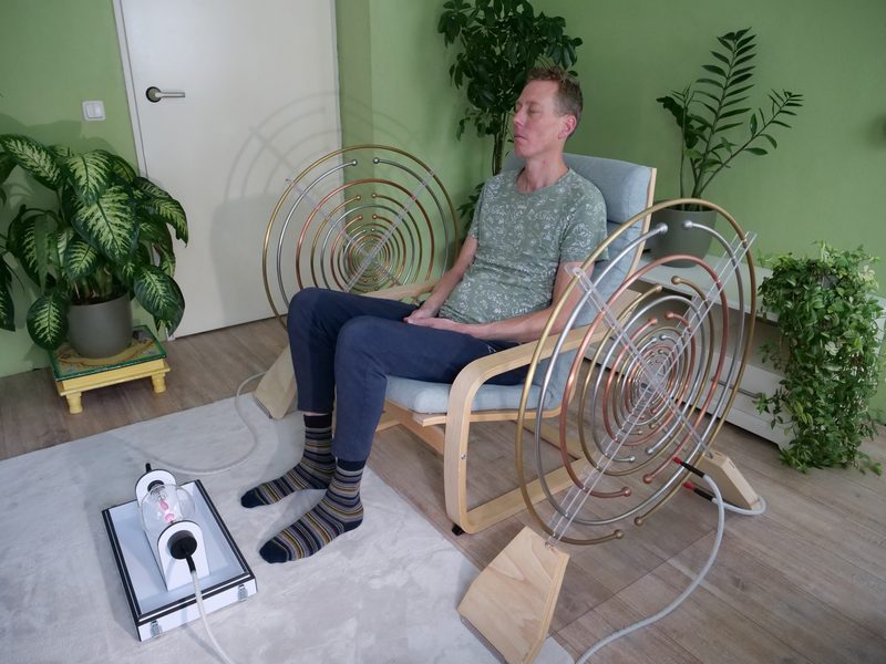 Multiwave Oscillator met de Lakhovsky antennes aan weerszijden van de stoel